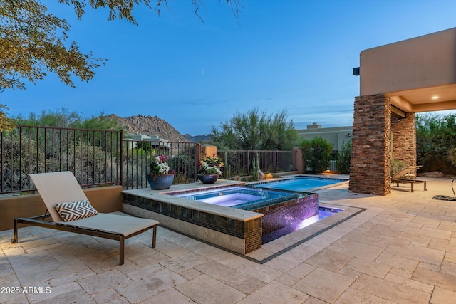 view of swimming pool with an in ground hot tub and a patio