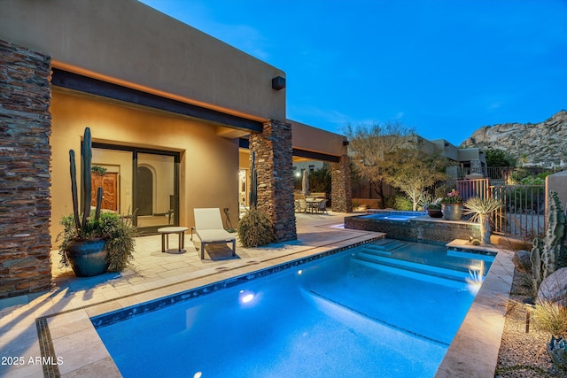 view of pool with an in ground hot tub, a mountain view, and a patio