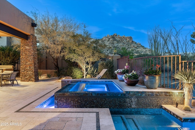 view of swimming pool with an in ground hot tub and a patio