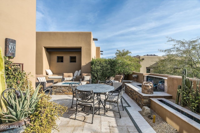 view of patio / terrace with an outdoor living space with a fire pit