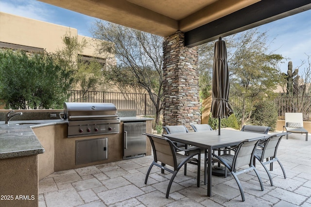 view of patio / terrace with area for grilling, sink, and an outdoor kitchen