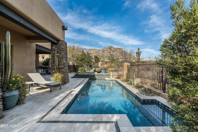 view of swimming pool featuring a mountain view and a patio area