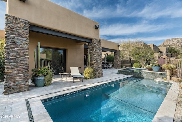 view of swimming pool featuring an in ground hot tub and a patio area