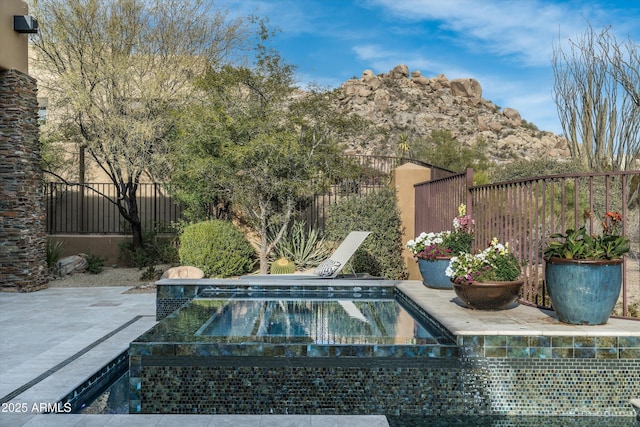 view of swimming pool with a patio and an in ground hot tub