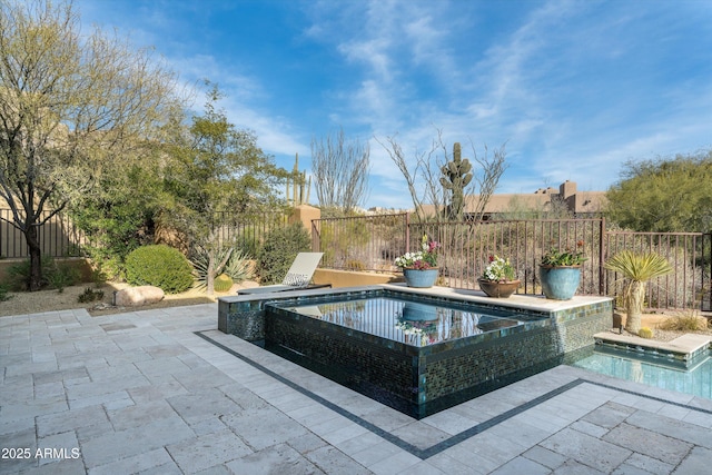 view of pool featuring an in ground hot tub and a patio area