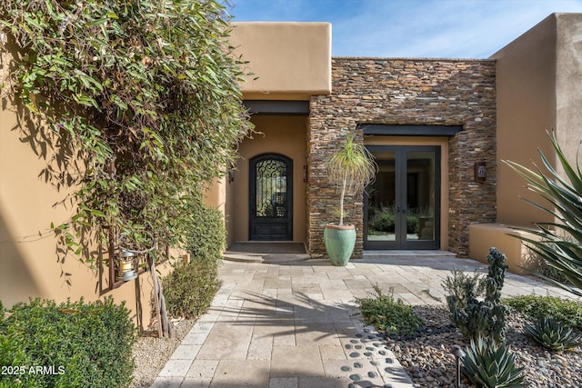 view of exterior entry featuring french doors