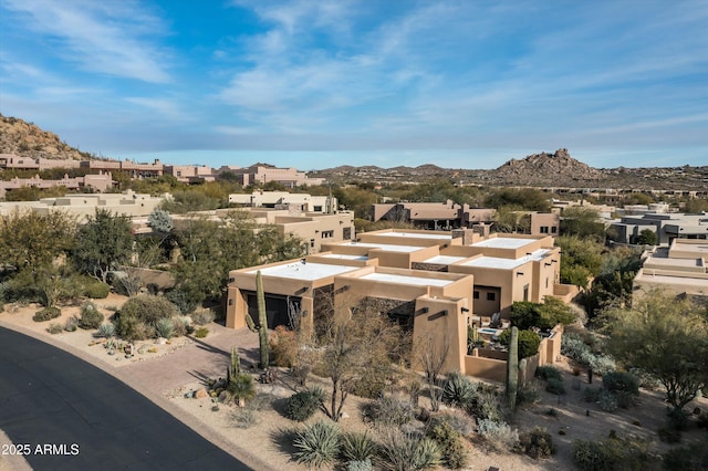 birds eye view of property featuring a mountain view