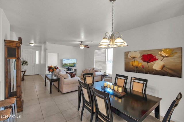 dining room featuring ceiling fan with notable chandelier and light tile floors