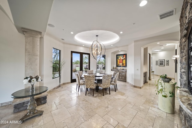 dining area featuring french doors and a raised ceiling