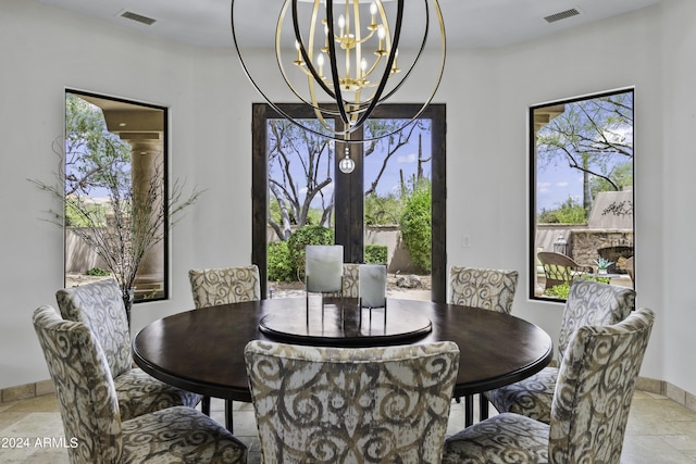 dining area featuring a healthy amount of sunlight and a chandelier