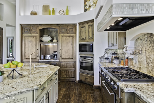 kitchen featuring black microwave, sink, stainless steel oven, light stone countertops, and custom range hood