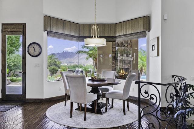 dining space with hardwood / wood-style floors, a mountain view, and a healthy amount of sunlight