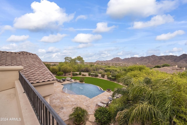 view of swimming pool with a mountain view and a patio