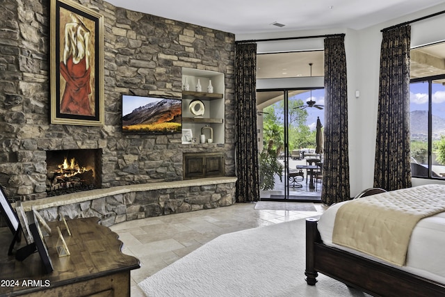 bedroom with access to exterior and a fireplace