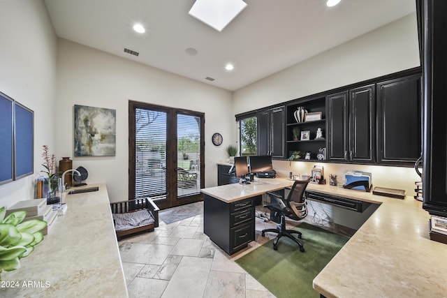 office space with french doors, a skylight, and sink