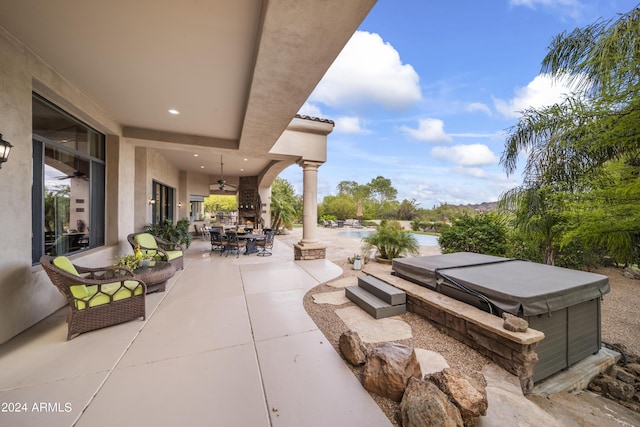 view of patio / terrace featuring a hot tub and ceiling fan