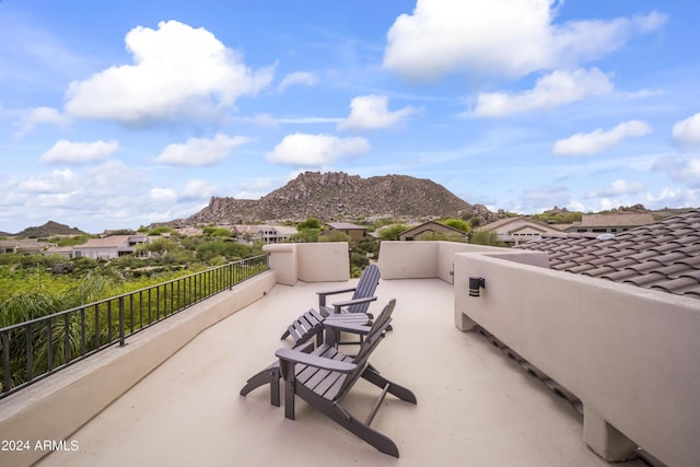 view of patio / terrace featuring a mountain view and a balcony