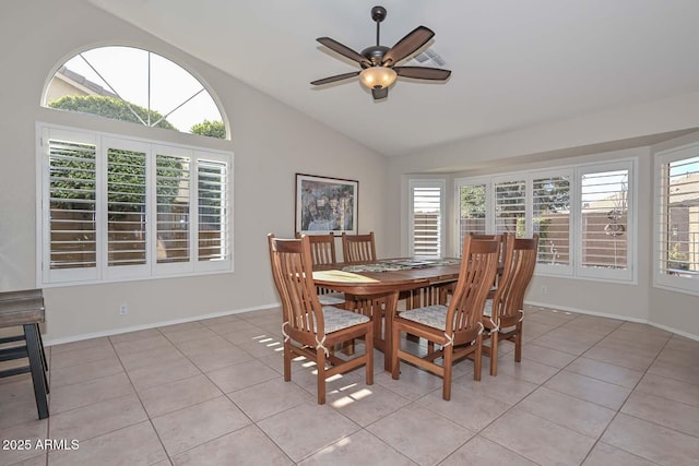 tiled dining room featuring ceiling fan and vaulted ceiling