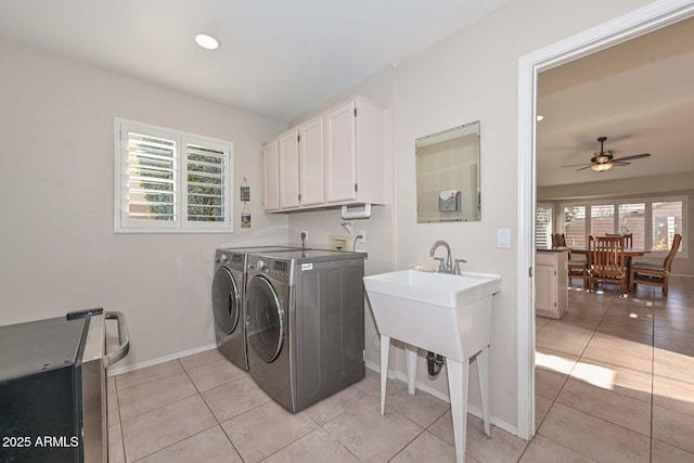 laundry room featuring cabinets, washing machine and clothes dryer, ceiling fan, and light tile patterned floors