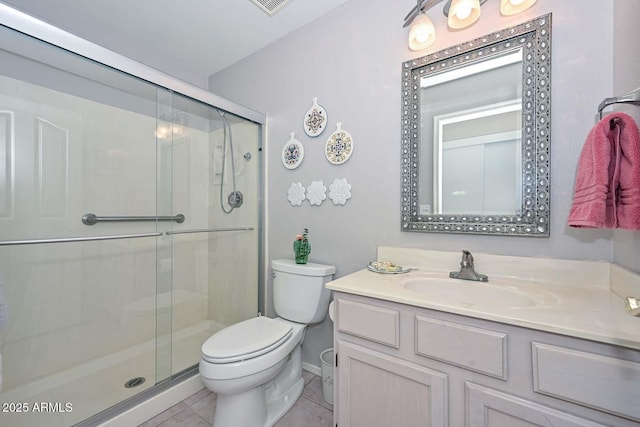 bathroom with vanity, tile patterned floors, toilet, and walk in shower