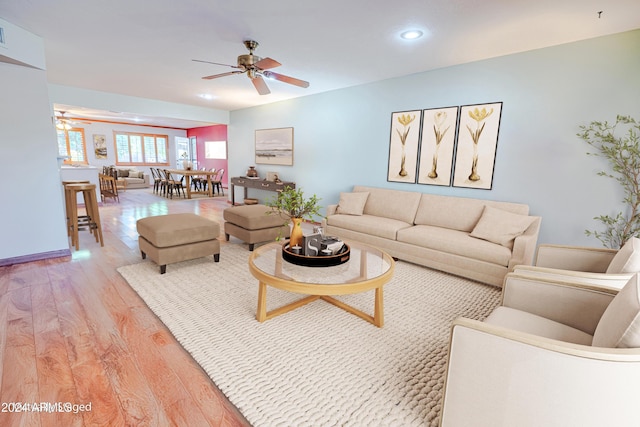 living room featuring ceiling fan and light wood-type flooring