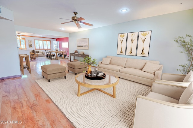 living room with light hardwood / wood-style floors and ceiling fan