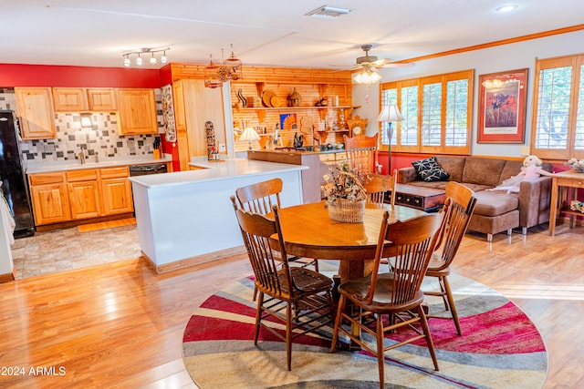 dining room featuring ceiling fan, sink, and light hardwood / wood-style floors