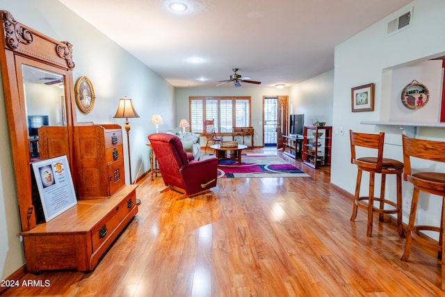 living room with ceiling fan and light hardwood / wood-style floors