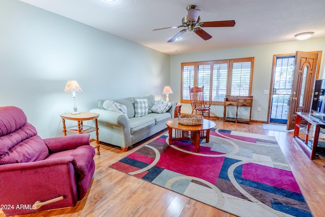 living room featuring light wood-type flooring and ceiling fan