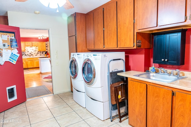 laundry room with cabinets, ceiling fan, sink, washer and dryer, and light tile patterned flooring