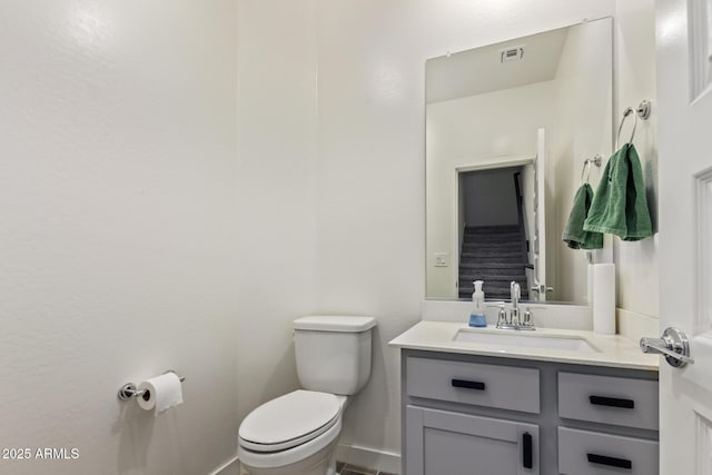 bathroom with toilet and vanity