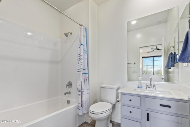 full bathroom featuring toilet, shower / bathtub combination with curtain, ceiling fan, and vanity