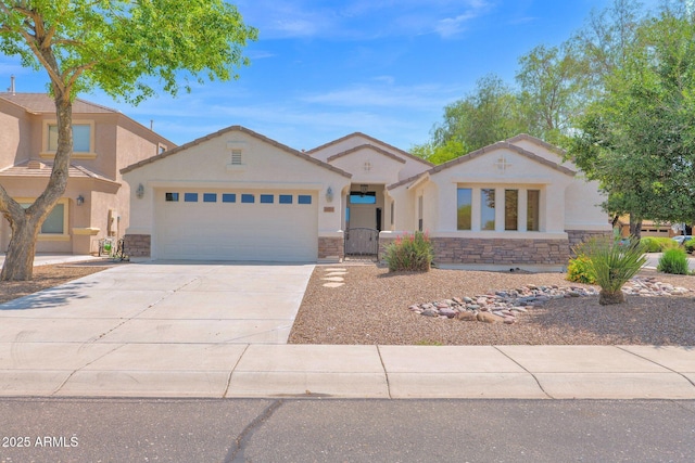 2620 E Rustling Oaks Ln, Phoenix, AZ 85024 - view of front of house with stone siding, stucco siding, a garage, and concrete driveway
