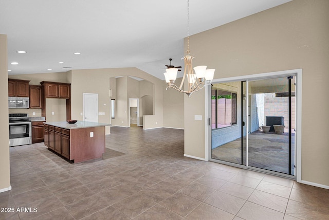 2620 E Rustling Oaks Ln, Phoenix, AZ 85024 - kitchen with appliances with stainless steel finishes, arched walkways, light countertops, vaulted ceiling, and open floor plan