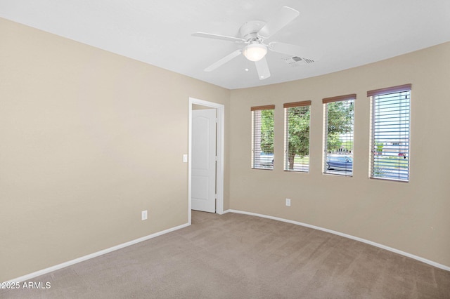 2620 E Rustling Oaks Ln, Phoenix, AZ 85024 - unfurnished room with ceiling fan, baseboards, and light carpet
