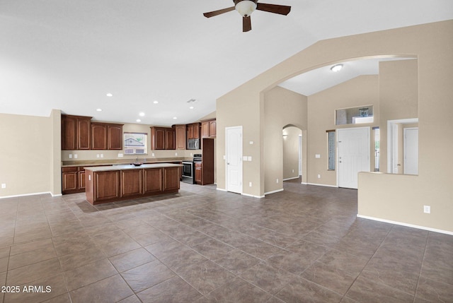 2620 E Rustling Oaks Ln, Phoenix, AZ 85024 - kitchen featuring open floor plan, ceiling fan, a center island, light countertops, and arched walkways