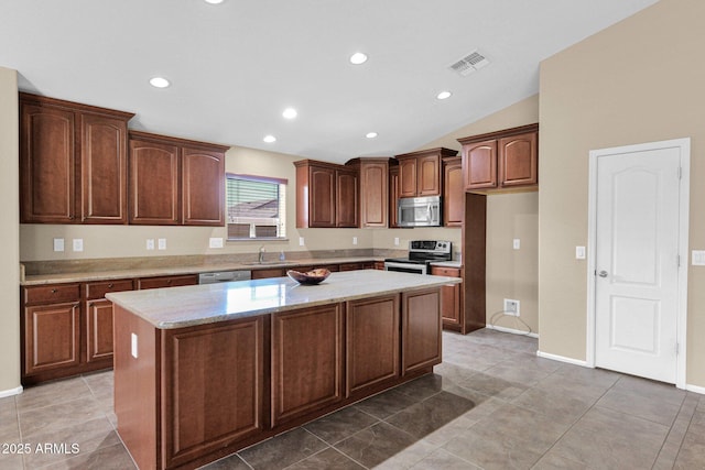 2620 E Rustling Oaks Ln, Phoenix, AZ 85024 - kitchen with appliances with stainless steel finishes, a sink, a kitchen island, recessed lighting, and light stone counters