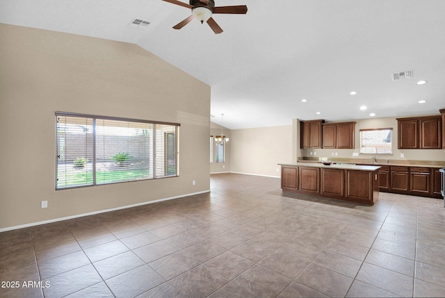 2620 E Rustling Oaks Ln, Phoenix, AZ 85024 - kitchen featuring lofted ceiling, open floor plan, ceiling fan, light countertops, and a chandelier