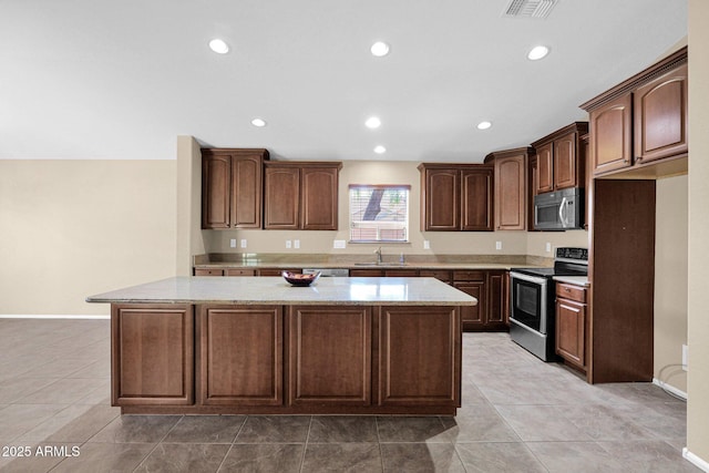 2620 E Rustling Oaks Ln, Phoenix, AZ 85024 - kitchen with appliances with stainless steel finishes, a sink, a center island, recessed lighting, and light stone countertops