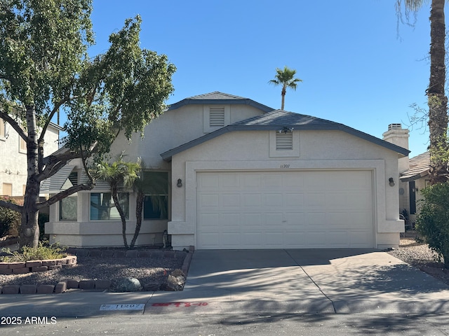 11207 N 59th Dr, Glendale, AZ 85304 - view of front facade featuring a garage, concrete driveway, and stucco siding