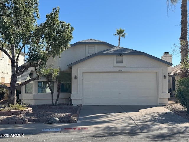 view of front facade featuring a garage, concrete driveway, and stucco siding