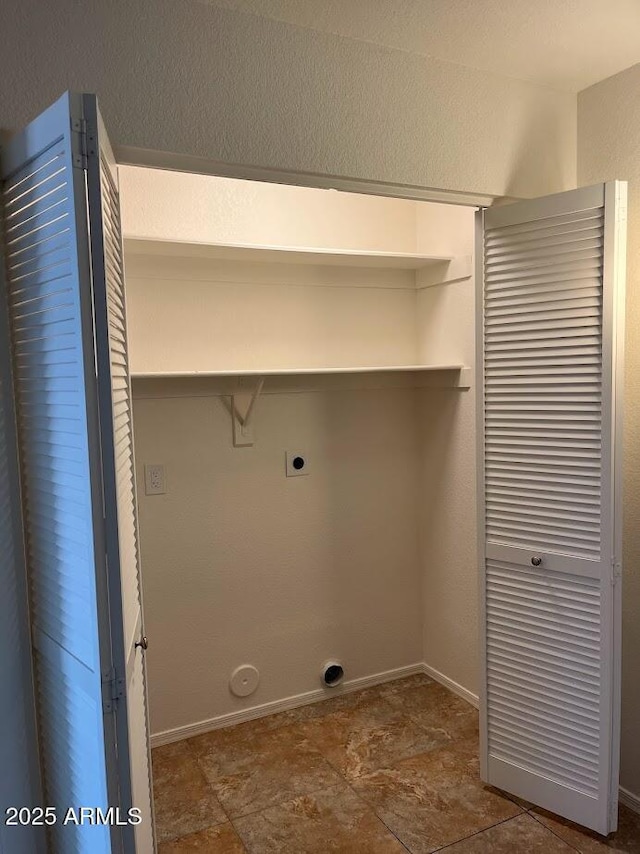 laundry room with laundry area, electric dryer hookup, and baseboards