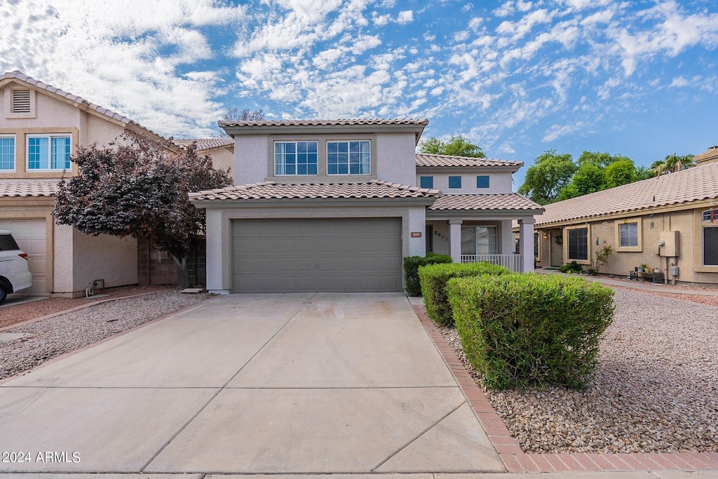 mediterranean / spanish home featuring a garage