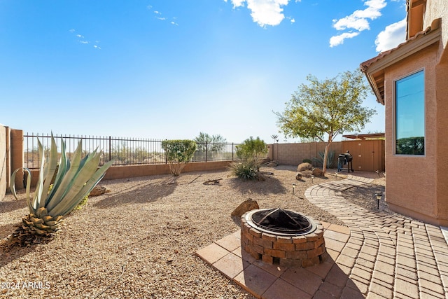 view of patio / terrace featuring an outdoor fire pit