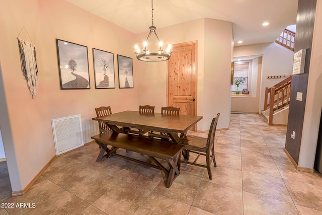 dining space featuring an inviting chandelier and light tile flooring