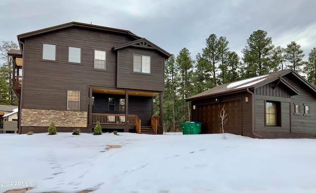 view of front of home featuring covered porch and a garage