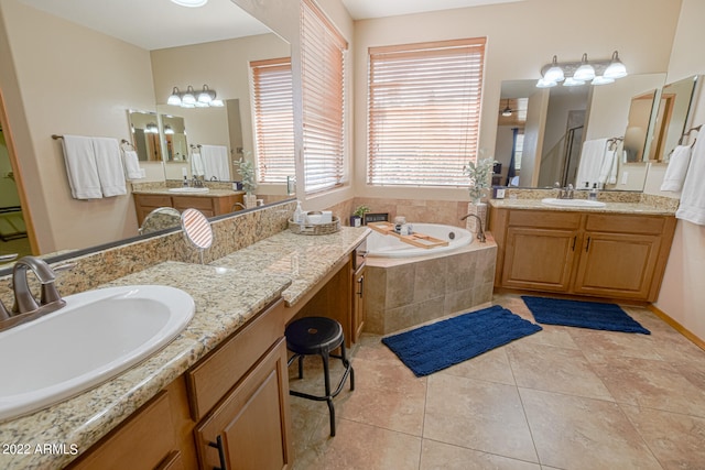 bathroom featuring tiled bath, tile flooring, and vanity