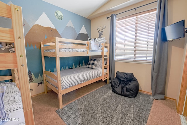 carpeted bedroom with multiple windows and lofted ceiling