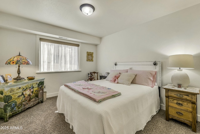 carpeted bedroom featuring baseboards and visible vents
