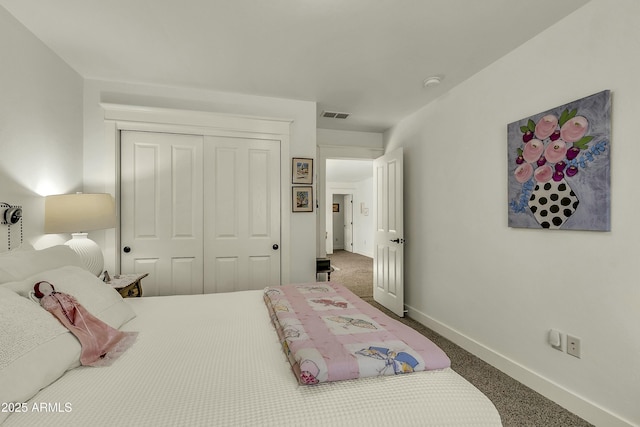 carpeted bedroom with baseboards, visible vents, and a closet
